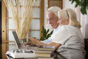 A happy elderly couple using a computer